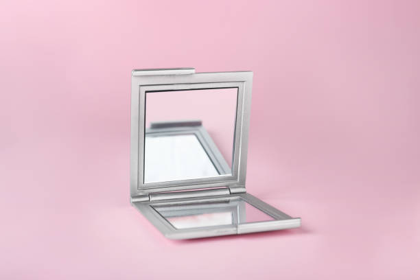 istock Stylish cosmetic pocket mirror on pink background 1736072714