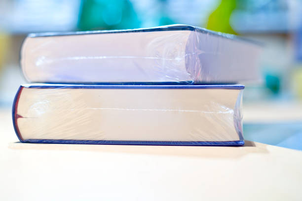 Two new Vacuum Packed Books on table "Two Vacuum Packed Books, shallow depth of field, space for content" civilized stock pictures, royalty-free photos & images