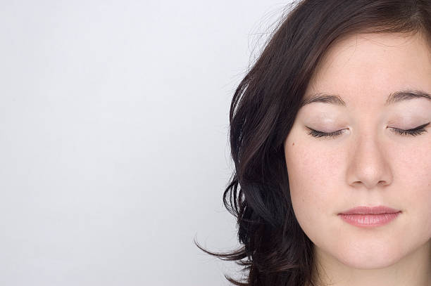 Portrait of a woman on the right side with her eyes closed stock photo