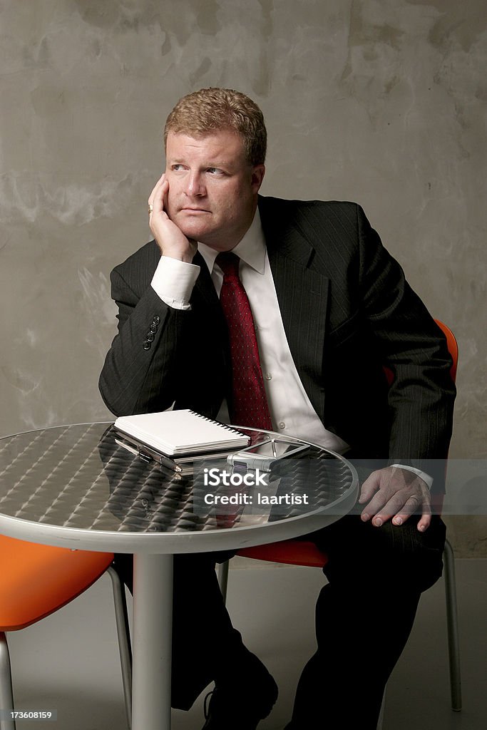 Lost in thought. A businessman rests his chin on his hand while concentrating on his next business model. Adult Stock Photo