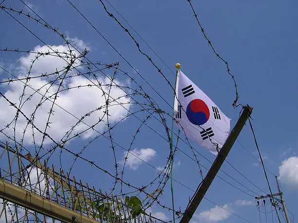 Korean flag seen through barbed wire at the DMZ, Panmunjeom, South Korea