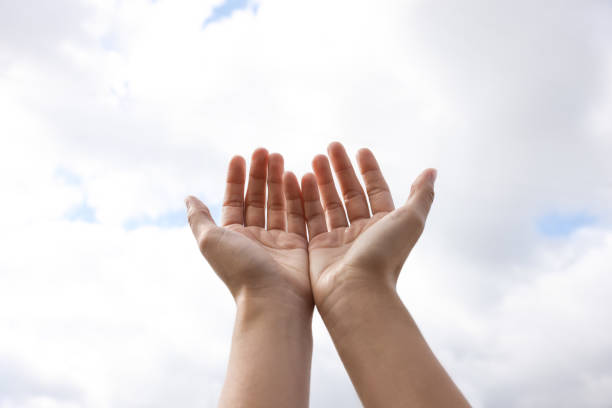 istock Woman reaching hands to blue sky outdoors on sunny day, closeup 1736088677