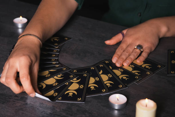 istock Soothsayer predicting future with tarot cards at table in darkness, closeup 1736089224