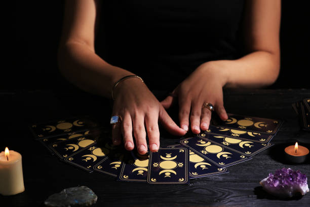 istock Soothsayer predicting future with tarot cards at table in darkness, closeup 1736089739