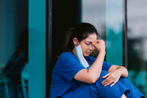 istock Stressed tired healthcare worker sitting on floor 1736101720