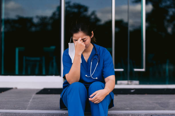 istock Worried and stressed doctor sitting on corridor 1736101734
