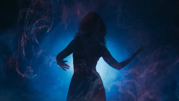 istock Mysterious dance woman silhouette swirls light 1736103434
