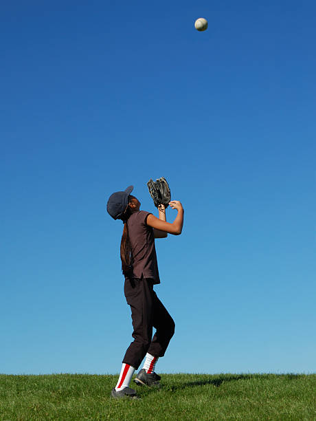 istock Young girl catching a fly ball 173610436