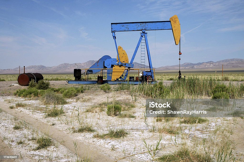 Desert Oil Pump Blue and yellow oil pump working in the desert. Basin - Montana Stock Photo
