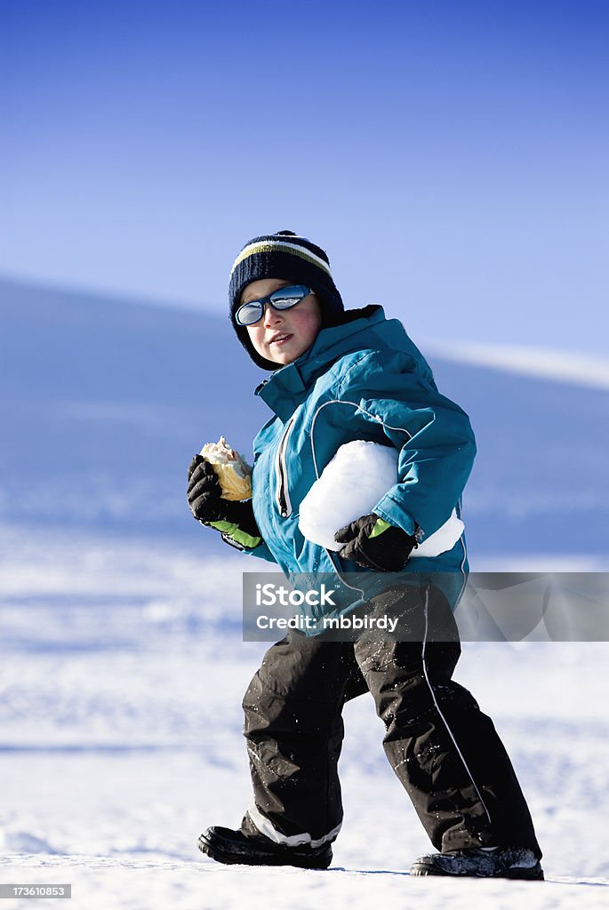 Boy having fun Boy having fun on snow holding sandwich and snowball. Canon 5D Mk II. Boys Stock Photo