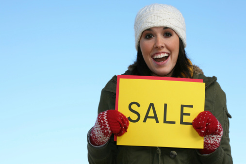 A girl with a sale sign. Plenty of copy space.