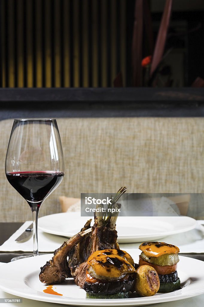 Meat on a bone Meat on bones and a glass of red wine at restaurant Red Wine Stock Photo