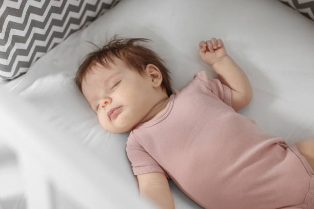 istock Cute little baby sleeping on cosy bed 1736118109