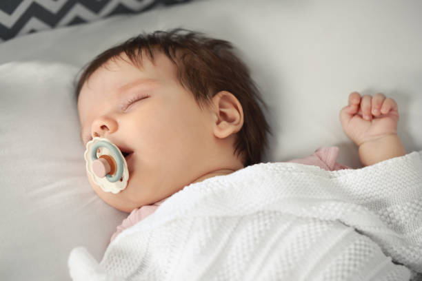 istock Cute little baby sleeping on cosy bed, closeup 1736123076