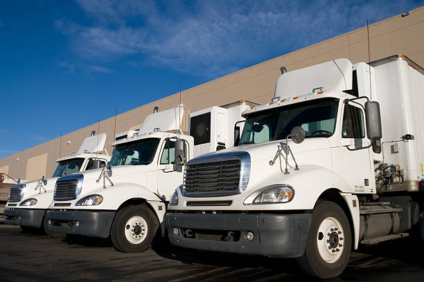 istock White Transportation Trucks at a Warehouse 173612532
