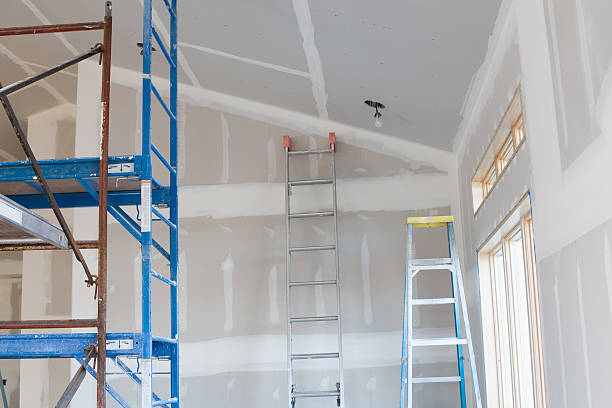 Drywall Taping, Scaffold, and Ladders in New Home Under Construction stock photo