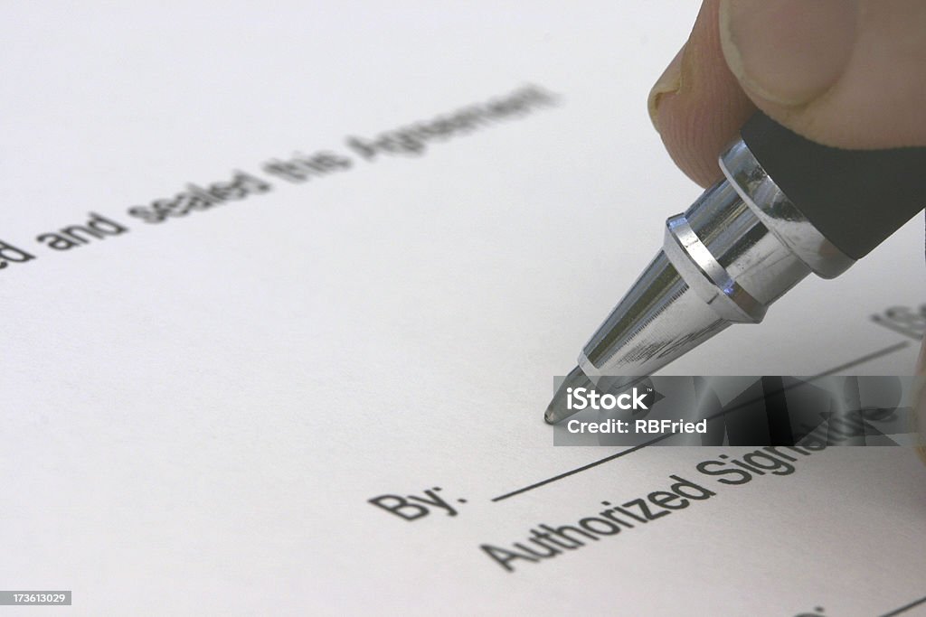 Closing a man signing an agreement Closing Stock Photo