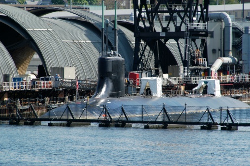 An image of a submarine in dry dock under construction.