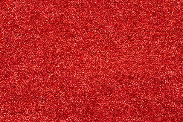 A closeup picture of a clean and bright red carpet Red coloured textured carpet background viewed flat, from above. rug stock pictures, royalty-free photos & images