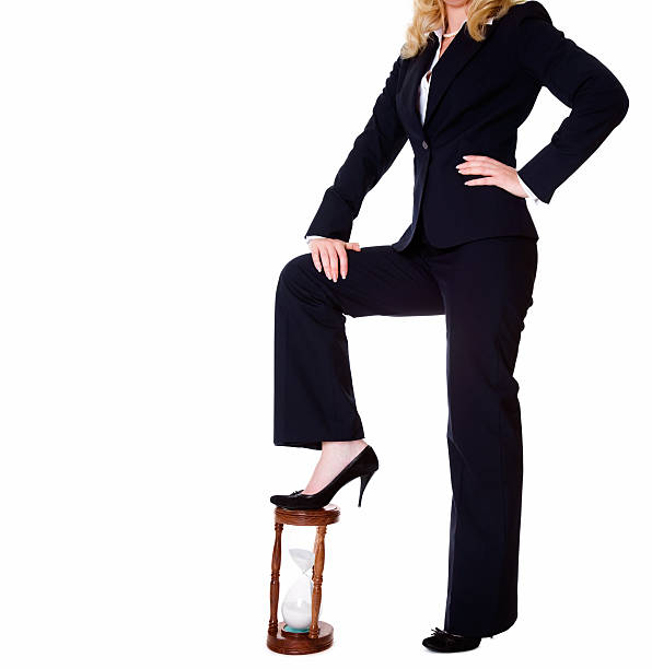 istock Businesswoman standing with one foot on timer 173613519