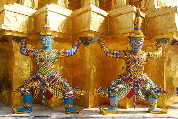 Two giants Sculpture and gold pagoda at Wat Phra Keow in Bangkok Thailand