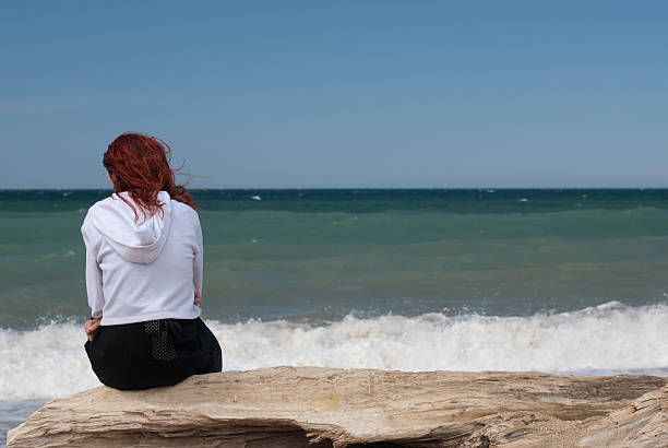 istock alone woman on seaside at storm 173615065
