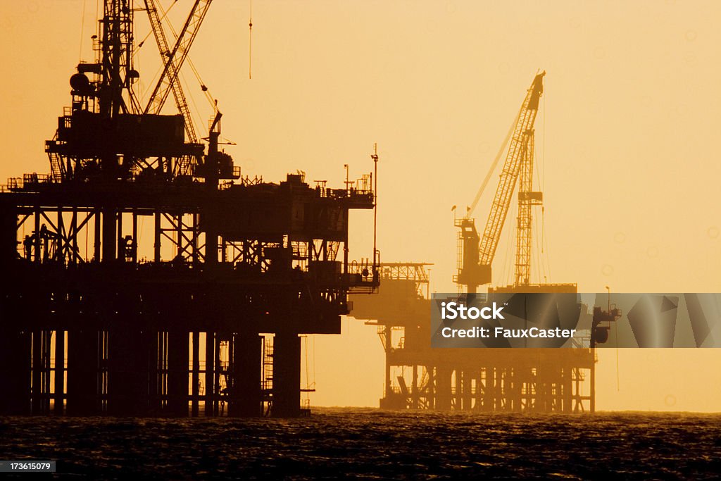Off shore  oil platforms at Sunset "800mm shot at sunset, expect atomospheric distortion. No EXIF date for manual 800mm lens." Offshore Platform Stock Photo