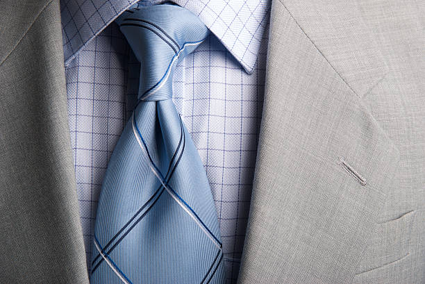 Businessman Suit and Tie Windsor Knot Checked Collar Close-Up "Close-up shot of a tight Windsor knotted tie, broad checked collar, and somber gray suit" mens fashion stock pictures, royalty-free photos & images