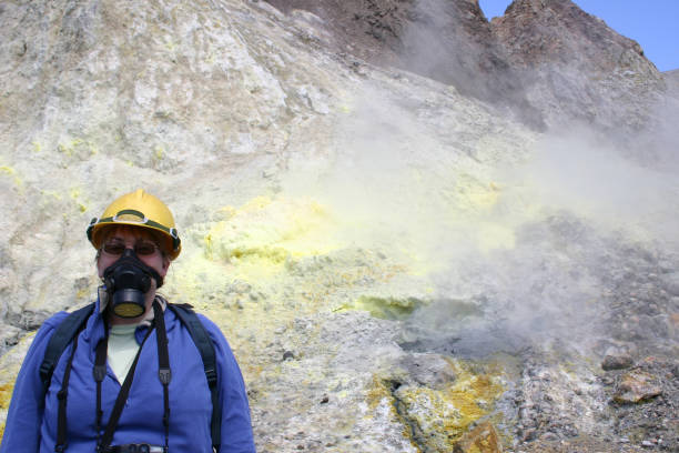 A striking yellow sulfur vent emerges from ethereal rock formations in Russia's volcanic expanse, showcasing nature's artistry amidst a remote and rugged landscape.