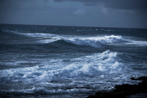 White salt water crashes on the shore