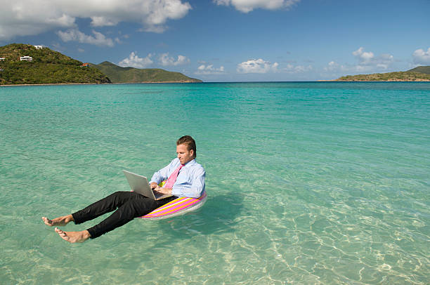istock Businessman Typing Floating in Tropical Waters 173615731