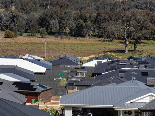istock Rooftops and backyards of new housing development 1736157807