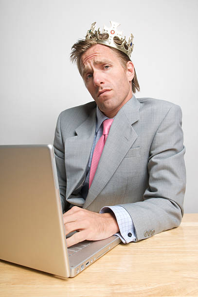 istock Snob Office Worker Businessman Wearing Crown at Des 173616440