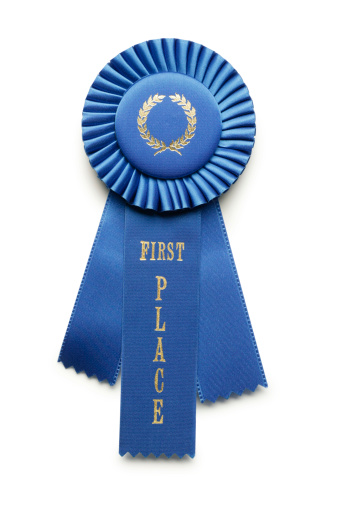 Close up of first place blue ribbon on white background.To see similar images click on the link below: