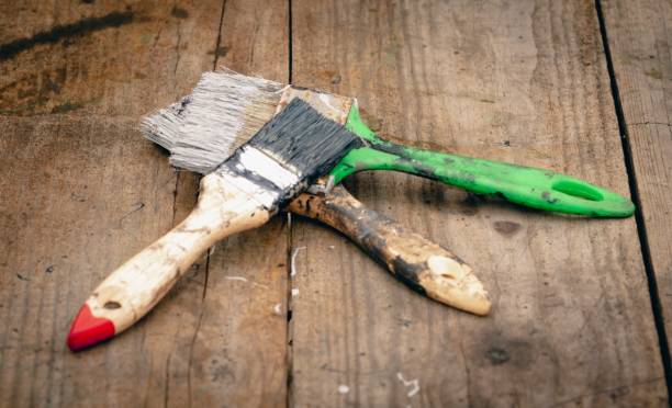 istock Brush covered with paint on a wooden background 1736168199