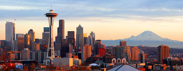 Seattle Skyline - Panorama Panorama of downtown Seattle and Mt. Rainier at sunset.   seattle photos stock pictures, royalty-free photos & images