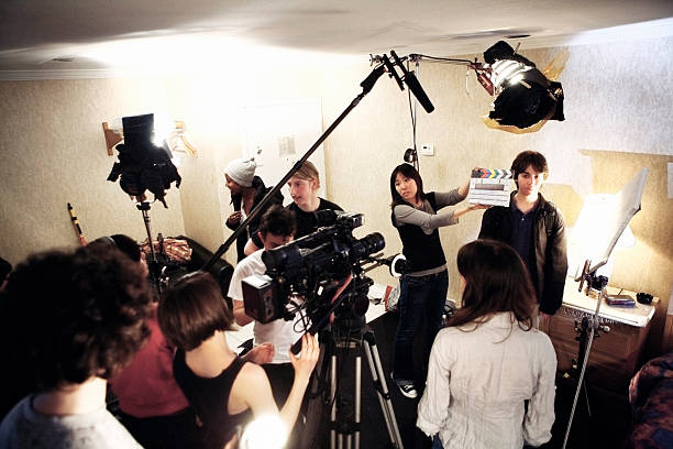 Film Crew - On Location "Right before a take, marker has snapped and it's time for action.Shot on a real set at high iso, some noise, view at 100%.More filmmaking images:" film crew stock pictures, royalty-free photos & images
