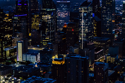The skyline of Houston, Texas illuminated at night shortly after sunset shot via helicopter from an altitude of about 900 feet.