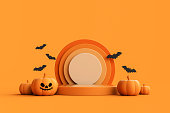 Jack-o-Lantern pumpkins with podium for product display and bats on orange background.