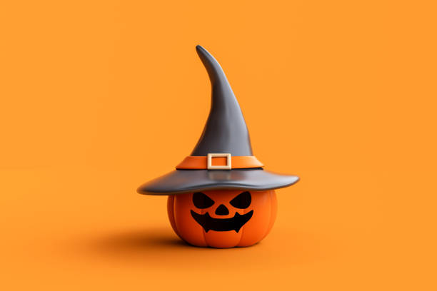 istock Jack-o-Lantern pumpkins wearing witch hat on orange background. 1736176567
