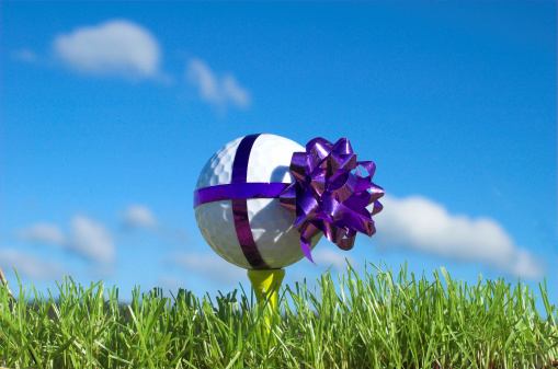 gift wrapped golf ball on tee