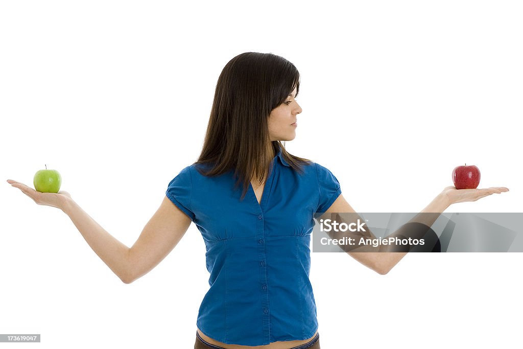 Balance Woman holding a red and a green apple on her hands Apple - Fruit Stock Photo