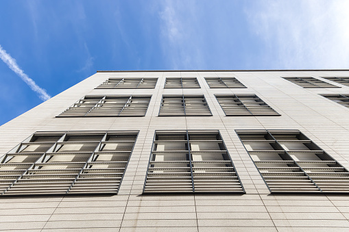 facade of an office building with window blinds for sun protection