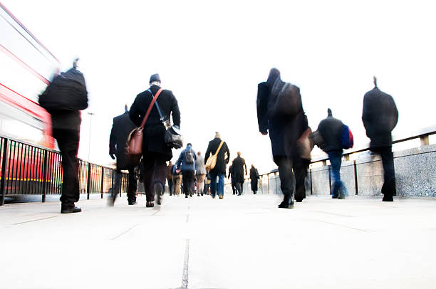 istock Back view of commuters with bags walking to work. 173619806