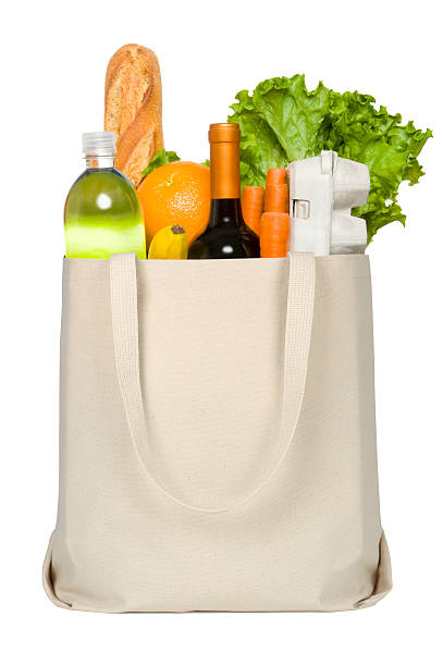 Close-up of credit card and groceries in canvas tote stock photo