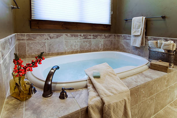 istock A luxurious bath with towels and flowers 173621605