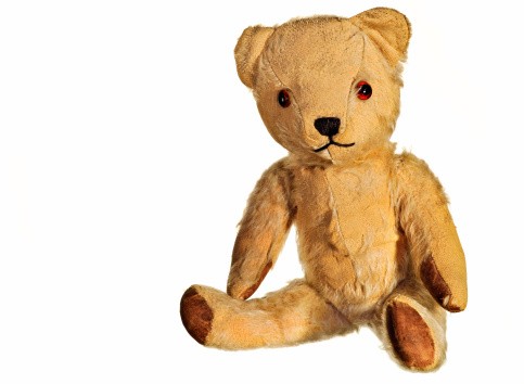 Old threadbare Teddy Bear isolated on white. The bear is 60 years old and not subject to design copyright