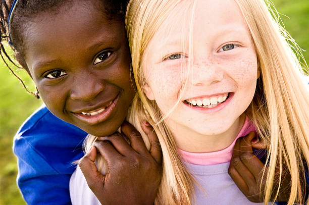 Two Happy Girls Smiling and Playing Together Outside