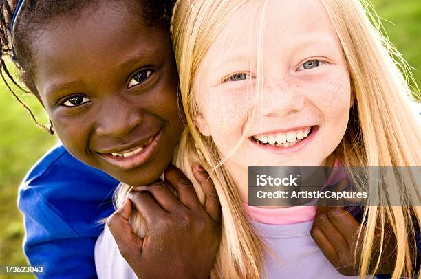 Two Happy Girls Smiling And Playing Together Outside Stock Photo - Download Image Now