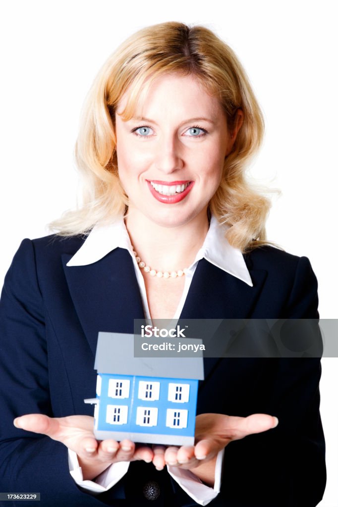 Happy businesswoman holding model house Closeup portrait of a happy young businesswoman holding model house 20-24 Years Stock Photo